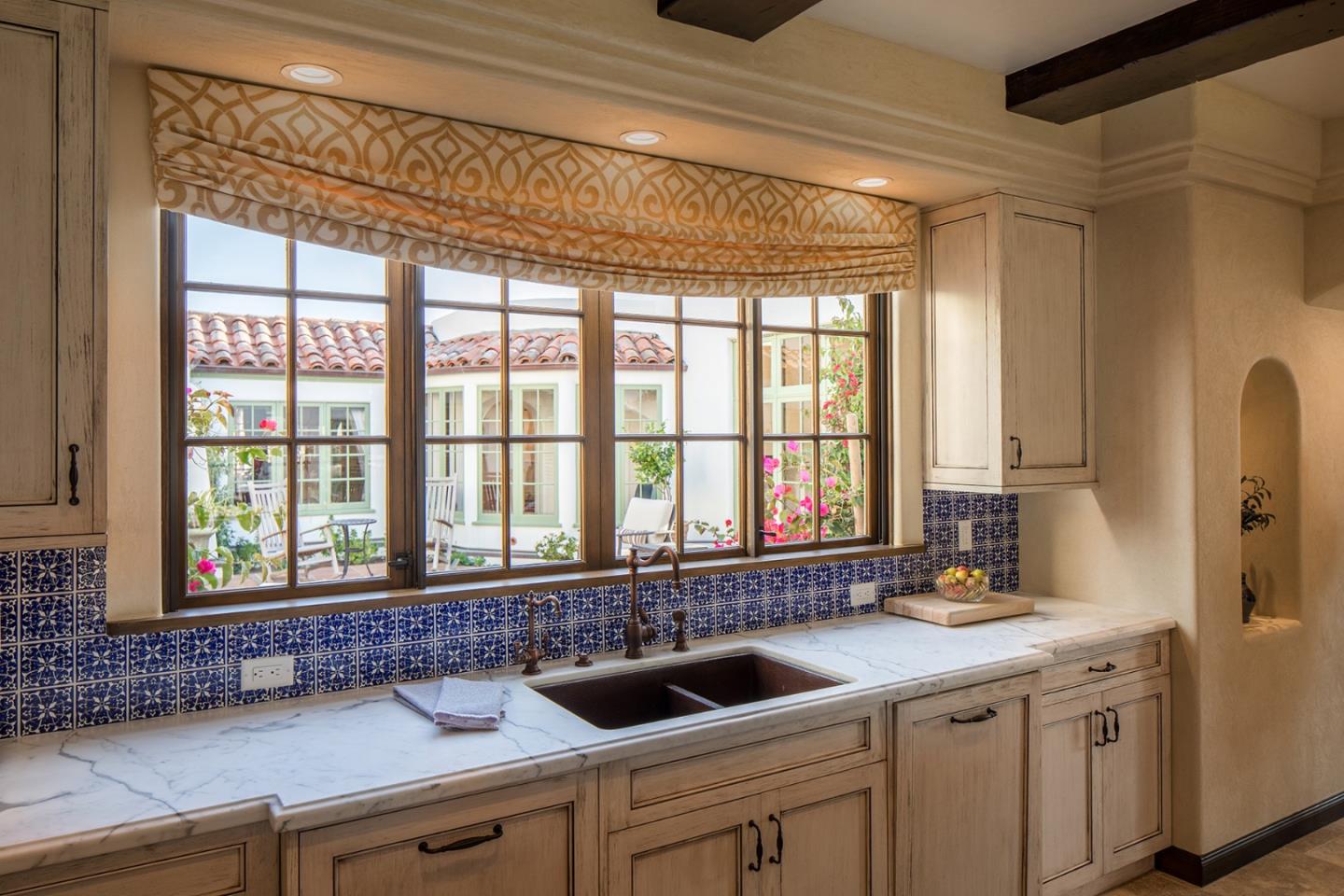 1011 Rodeo Road Pebble Beach, CA 93953 - Photo 7 of 41 a kitchen with a sink and large window
