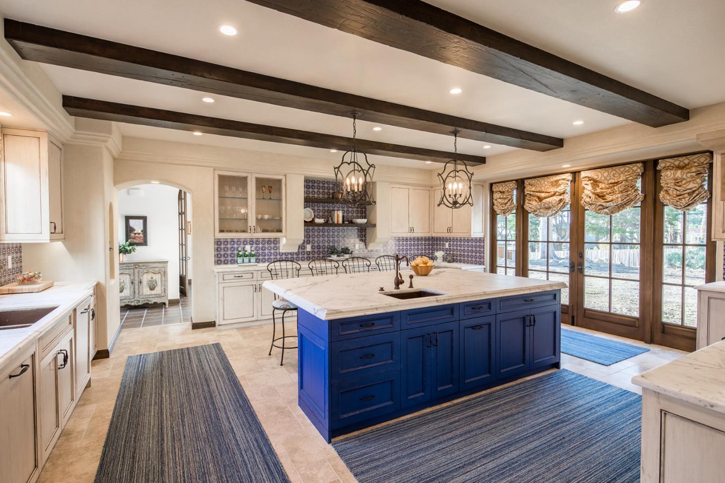 1011 Rodeo Road Pebble Beach, CA 93953 - Photo 10 of 41 a kitchen with stainless steel appliances granite countertop a sink stove and wooden floor