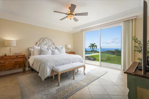 a spacious bedroom with a bed and a chandelier