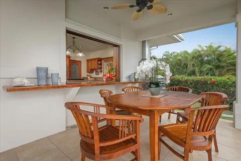 a dining room with furniture and a floor to ceiling window