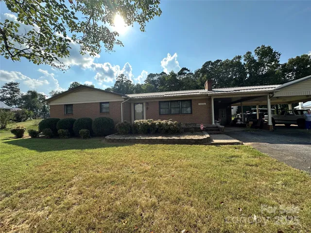 a view of a house with swimming pool and sitting area