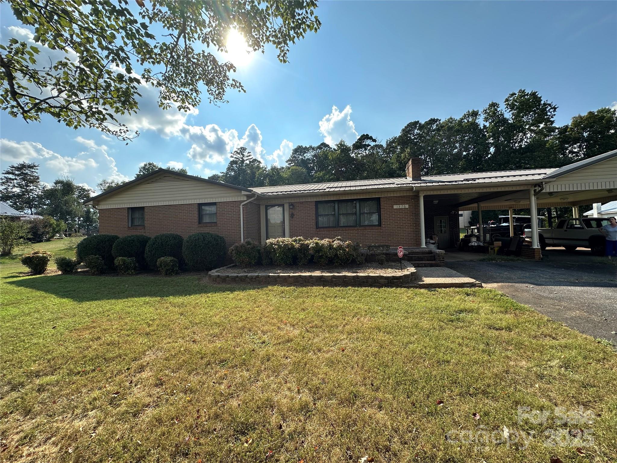 a view of a house with swimming pool and sitting area