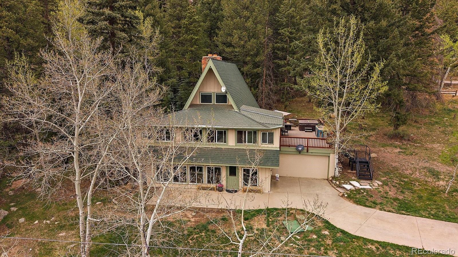 307 Snyder Mountain Road Evergreen, CO 80439 - Photo 3 of 41 a view of a house with a yard