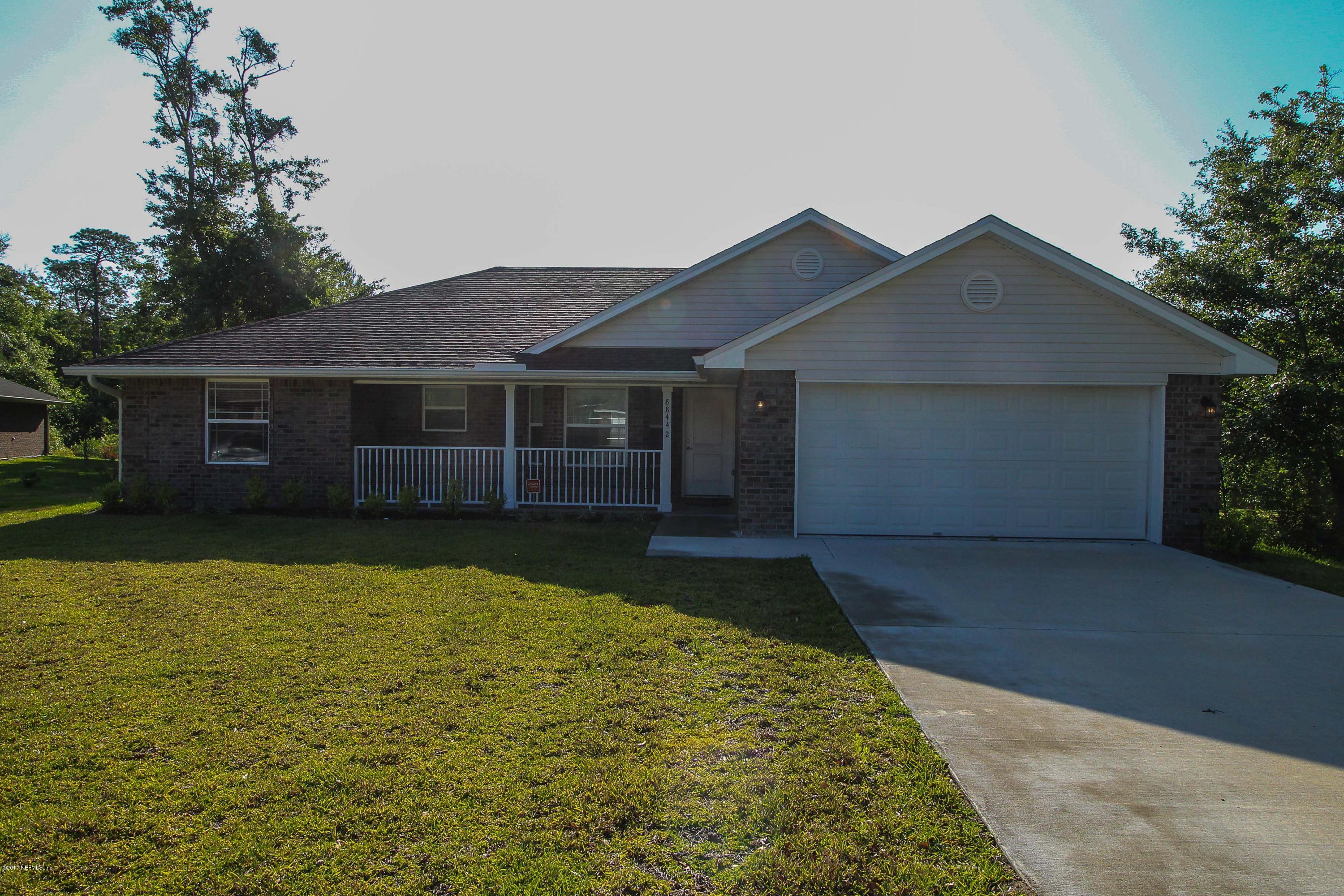 a front view of a house with yard