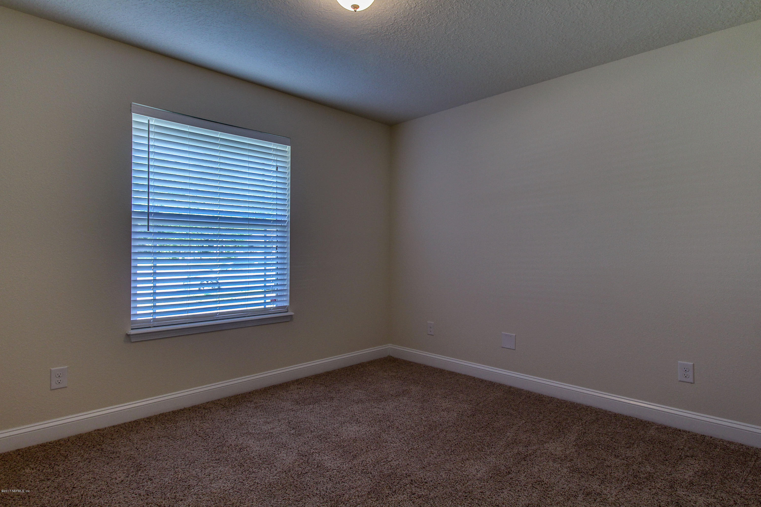 88442 Maybourne Road Yulee, FL 32097 - Photo 15 of 29 an empty room with a window