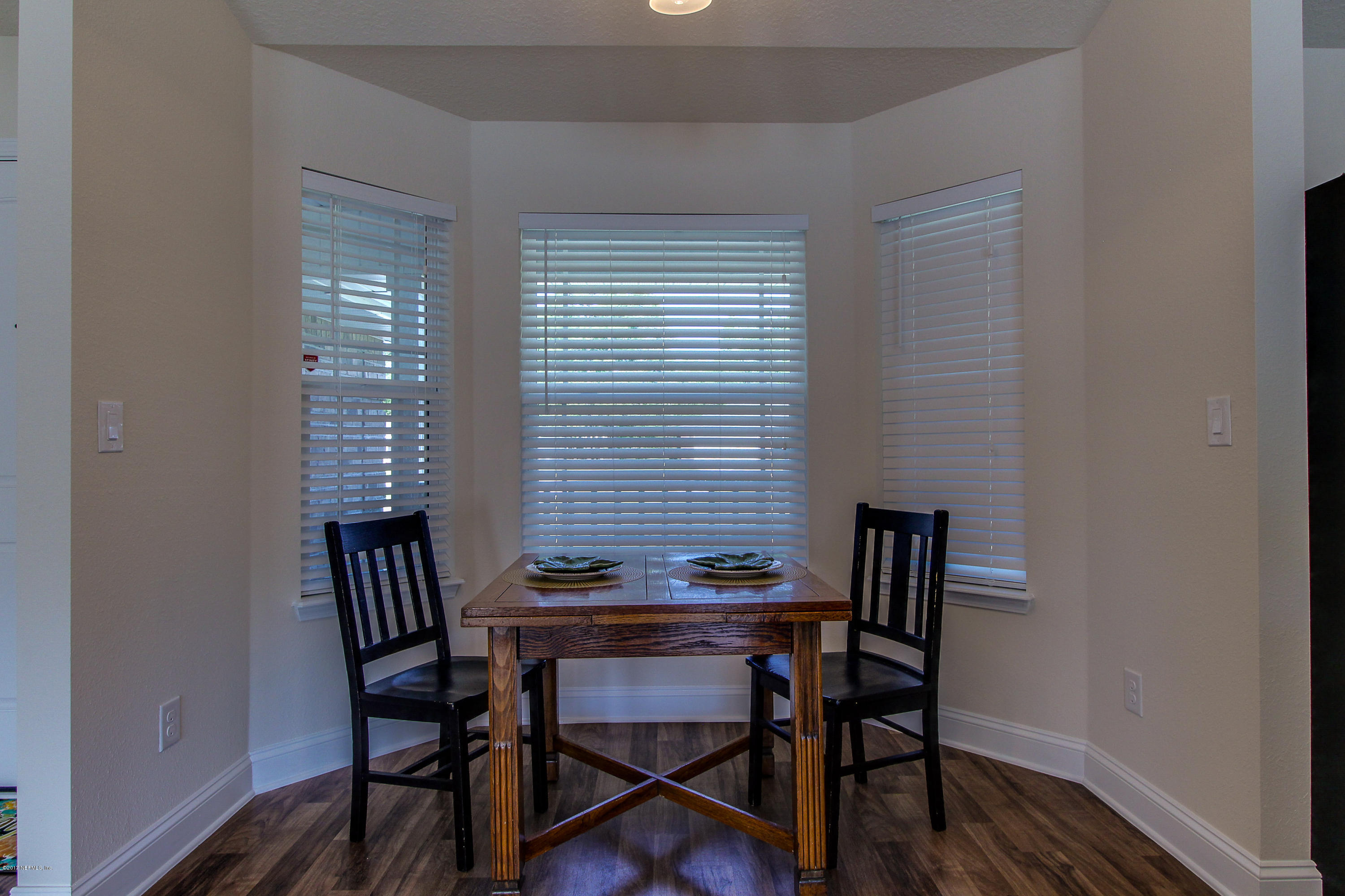 88442 Maybourne Road Yulee, FL 32097 - Photo 16 of 29 a view of a workspace with furniture and a window