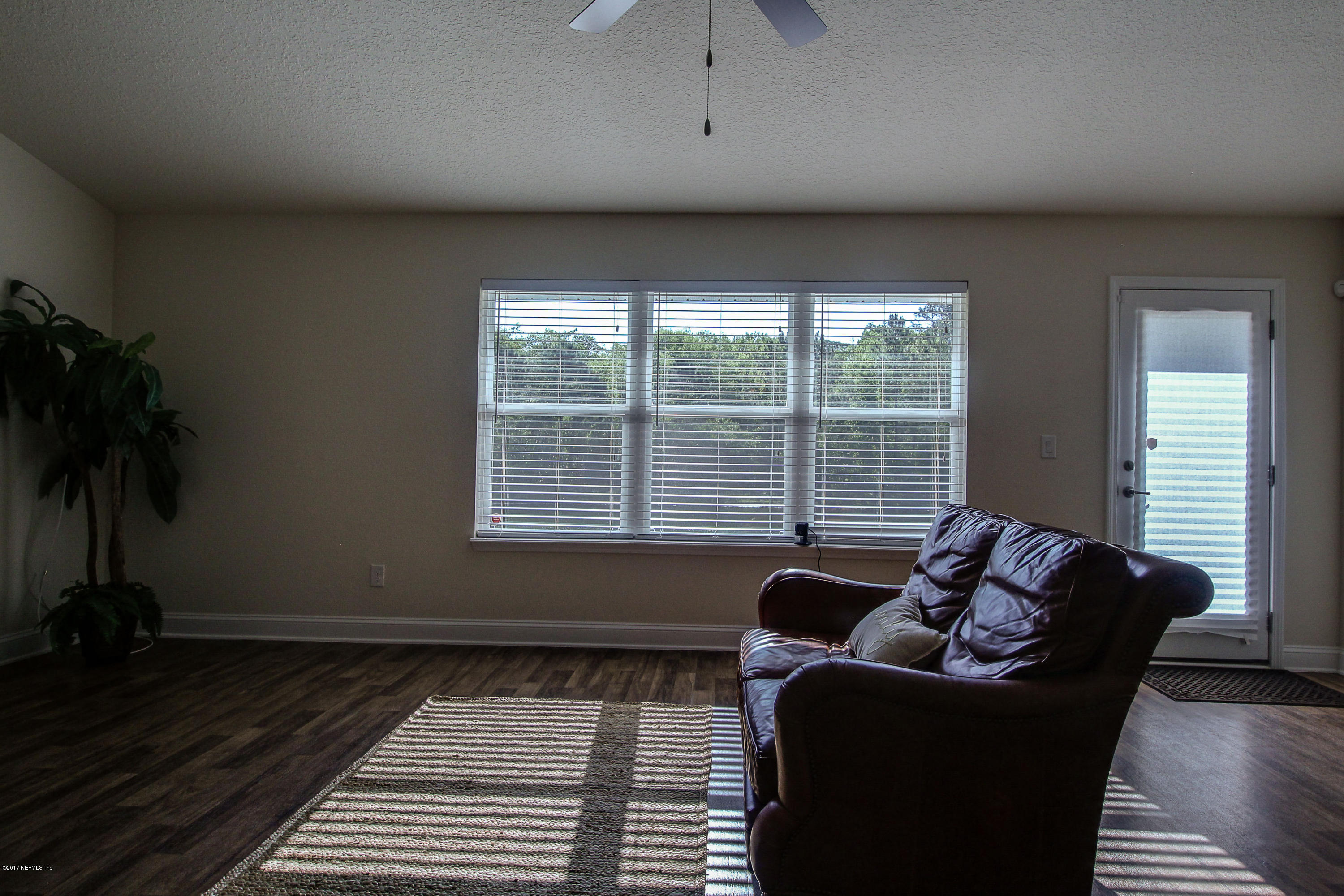 88442 Maybourne Road Yulee, FL 32097 - Photo 17 of 29 a living room with furniture and a window