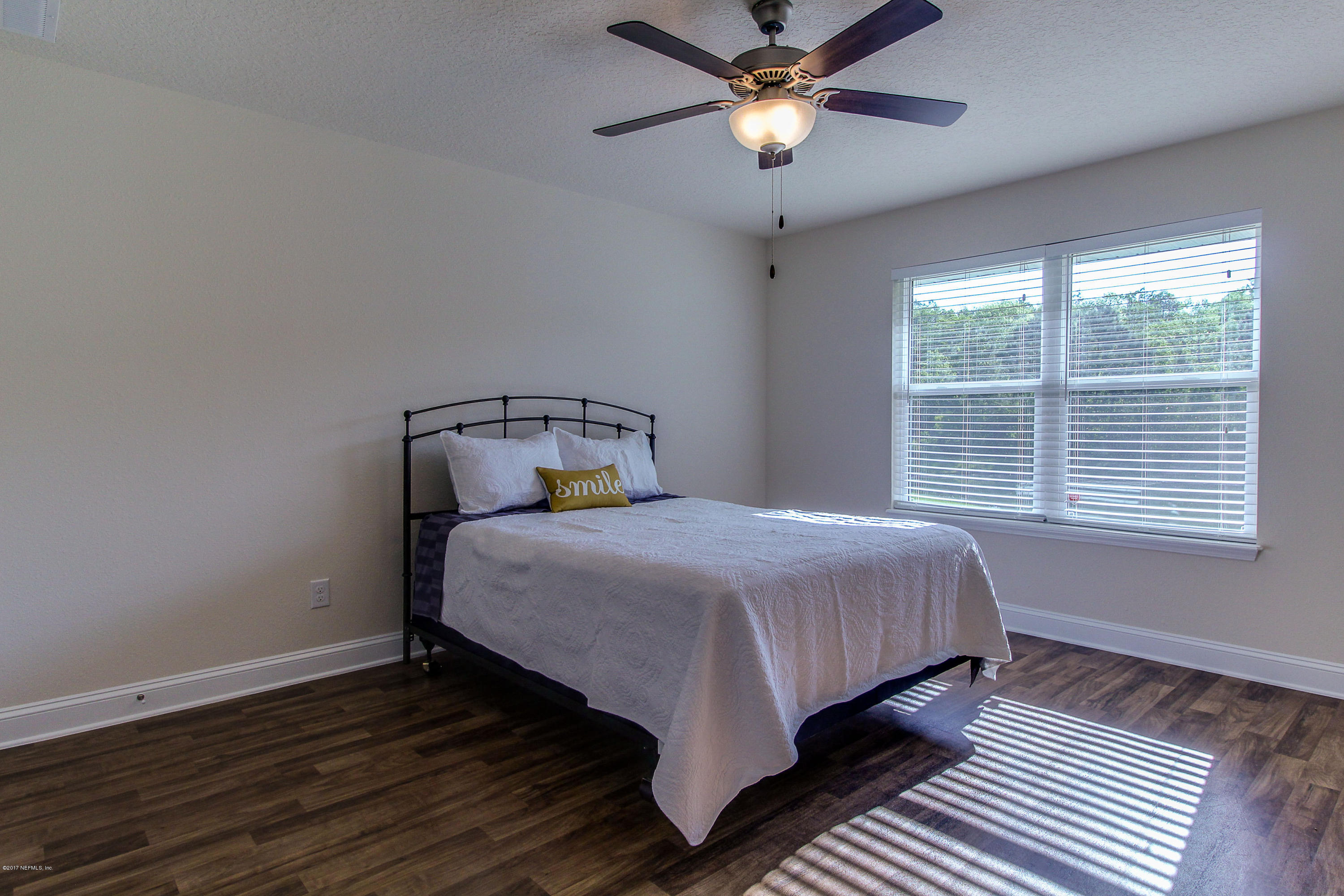 88442 Maybourne Road Yulee, FL 32097 - Photo 19 of 29 a bedroom with a bed and window