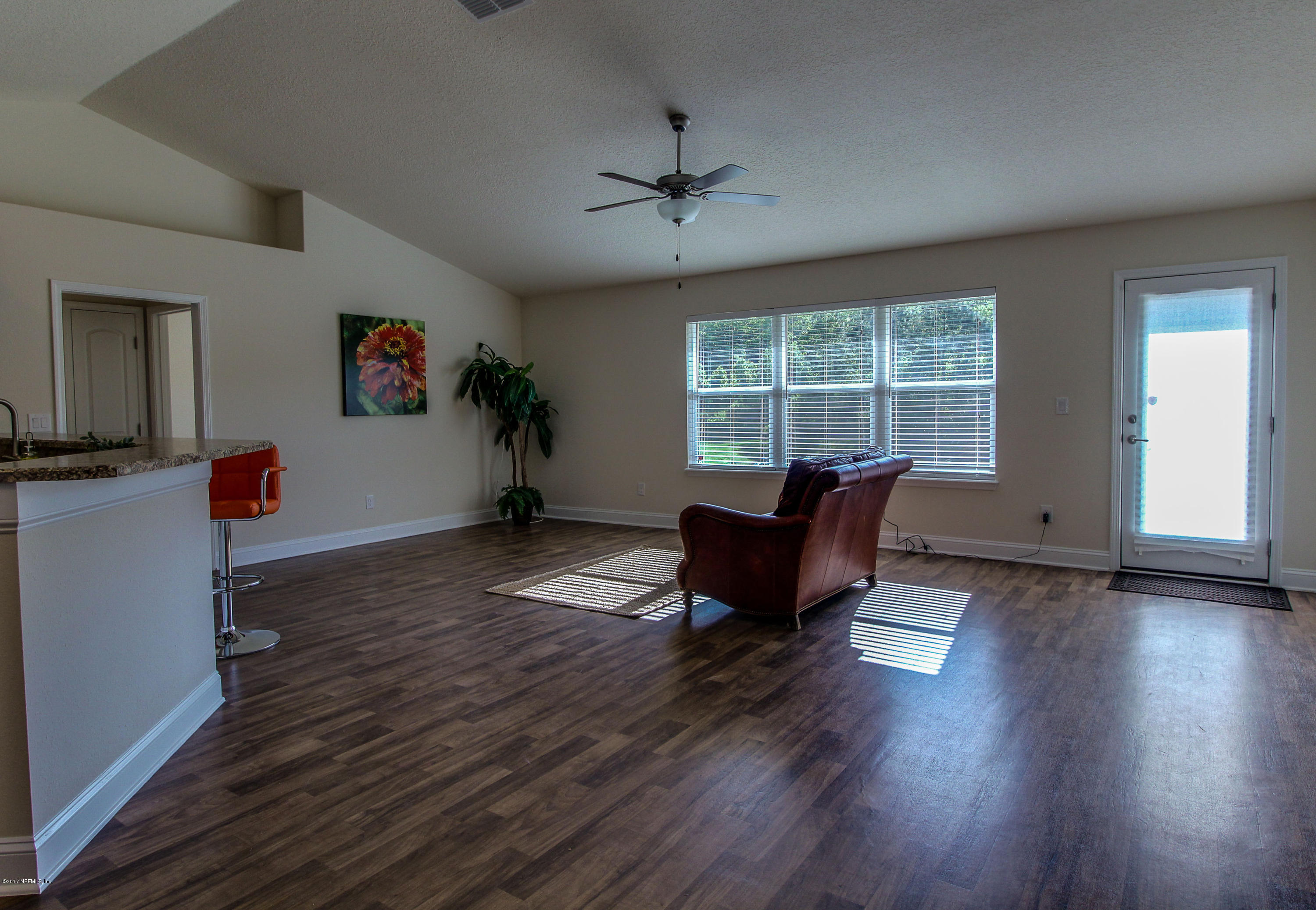 88442 Maybourne Road Yulee, FL 32097 - Photo 3 of 29 a living room with furniture and a wooden floor