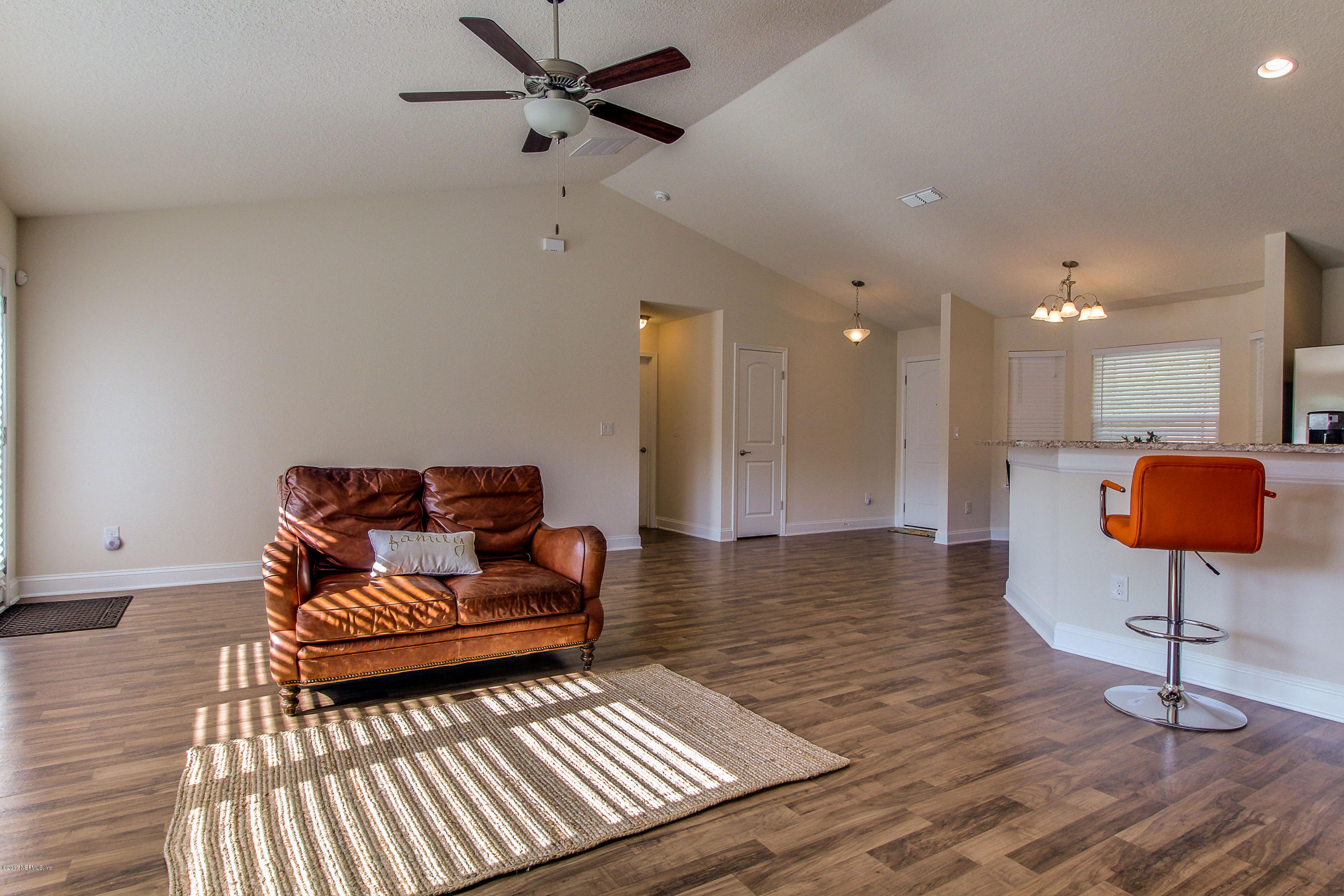 88442 Maybourne Road Yulee, FL 32097 - Photo 6 of 29 a living room with furniture and a wooden floor