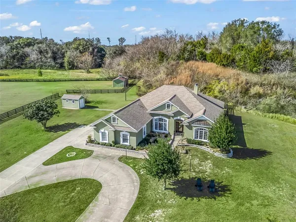 an aerial view of a house with big yard