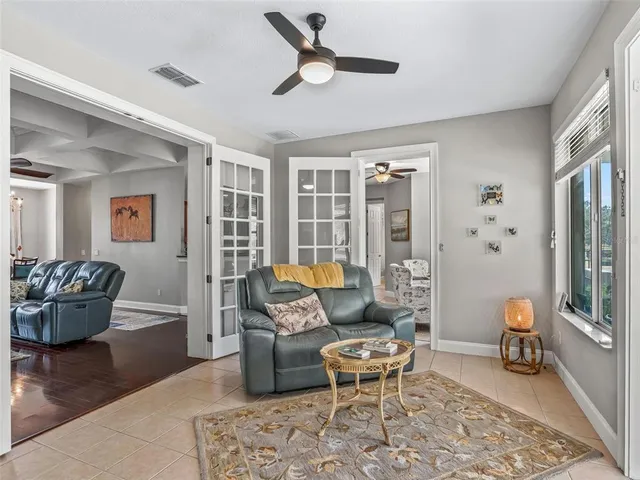 a living room with furniture and a potted plant