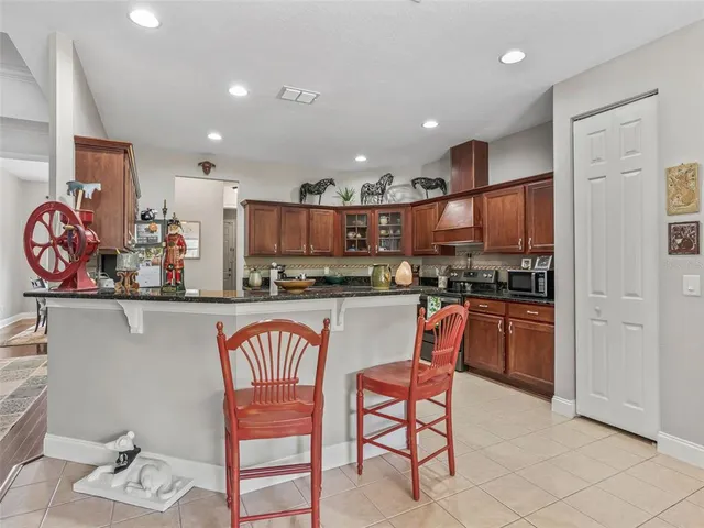 a kitchen with stainless steel appliances granite countertop a refrigerator and microwave