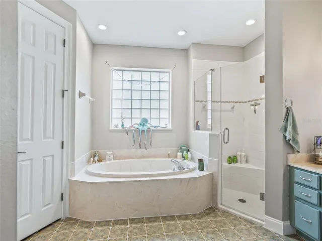 a bathroom with a tub sink and mirror