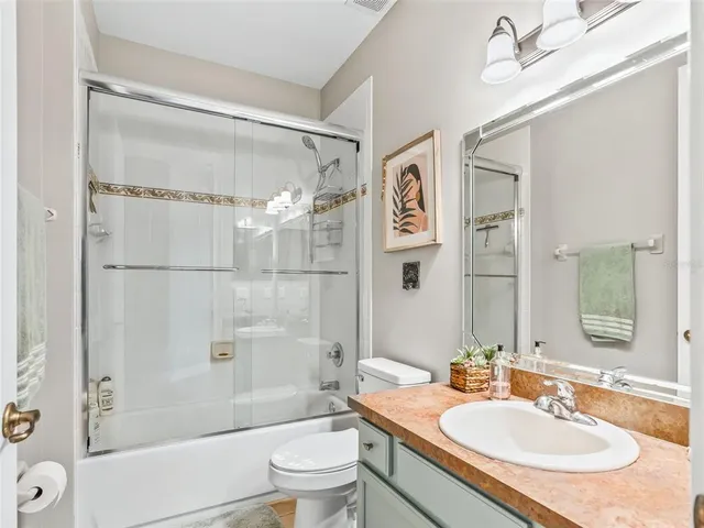 a living room with patio furniture and a floor to ceiling window