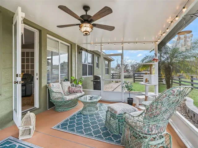 a view of a house with a big yard plants and large trees
