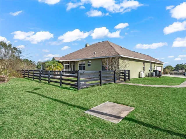 an aerial view of a house with outdoor space
