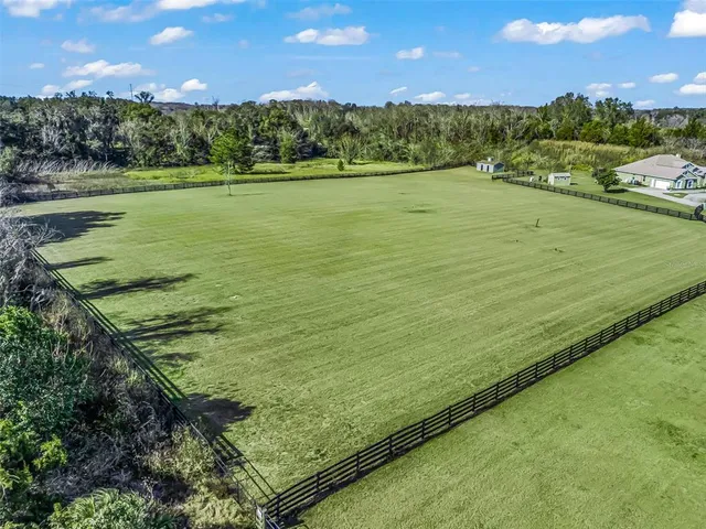 an aerial view of a golf course with outdoor space