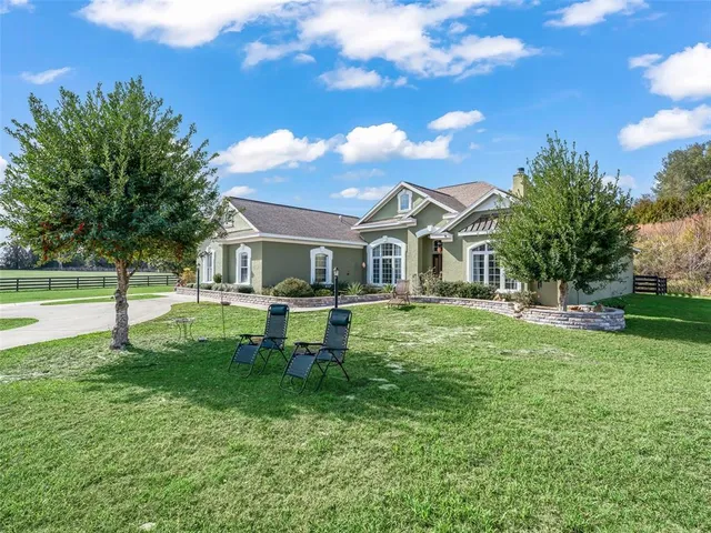 a view of a house with a yard porch and sitting area