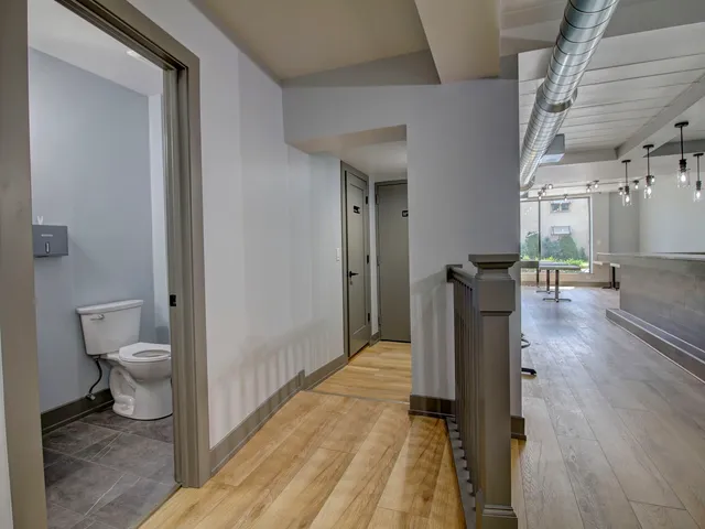 a spacious bathroom with a toilet and a shower