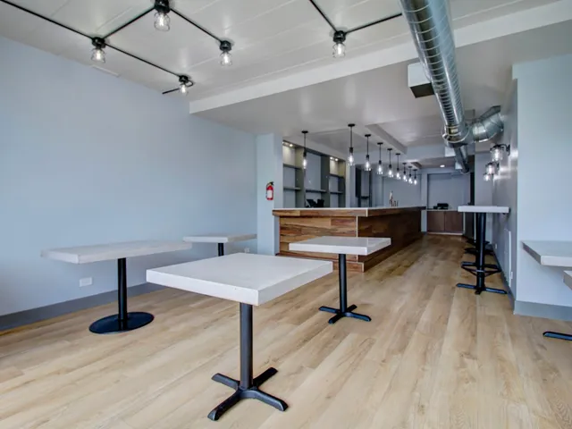 a room with lots of furniture and wooden floors