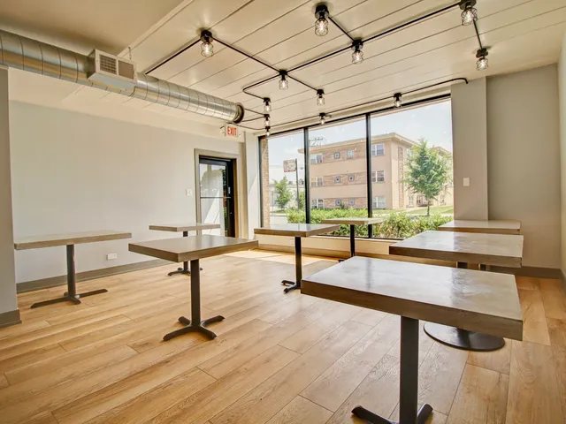 a view of a livingroom with furniture window and wooden floor