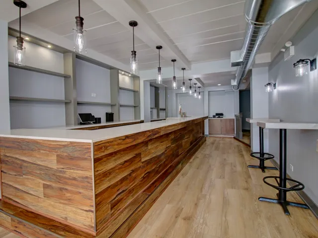 a large kitchen with stainless steel appliances kitchen island granite countertop a large island in the center