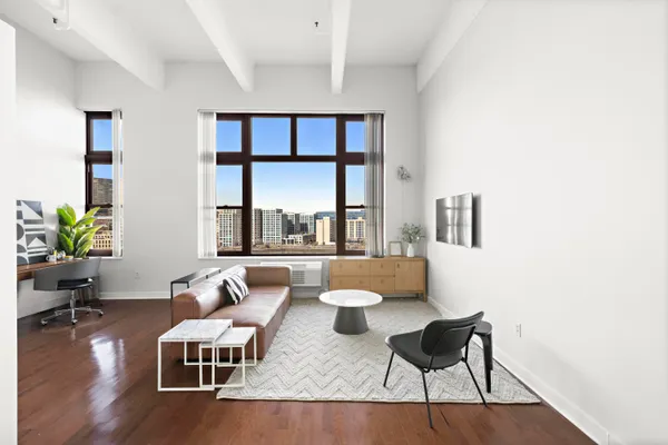 a living room with furniture and a large window