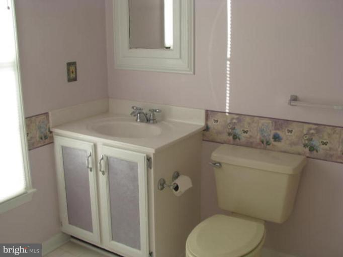 8388 Old Stillhouse Road Rixeyville, VA 22737 - Photo 3 of 15 a bathroom with a granite countertop toilet sink and mirror