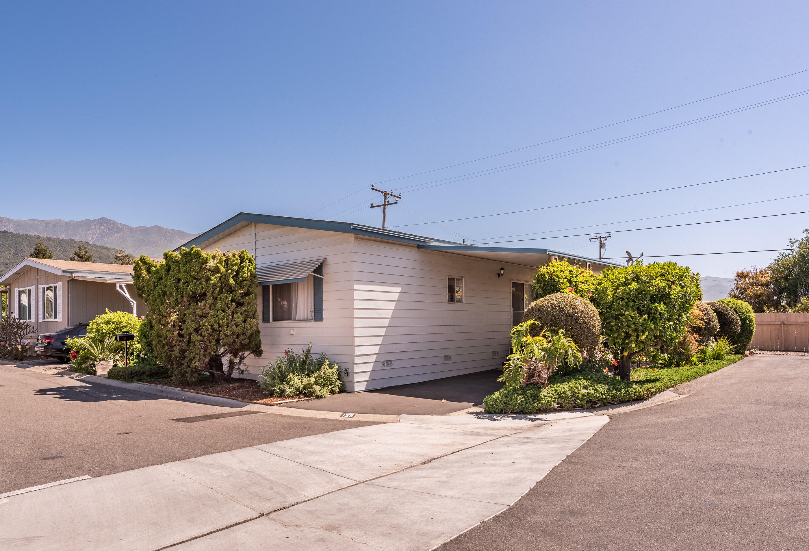 3950 Via Real, Unit 129 Carpinteria, CA 93013 - Photo 1 of 35 a front view of a house with a yard and garage
