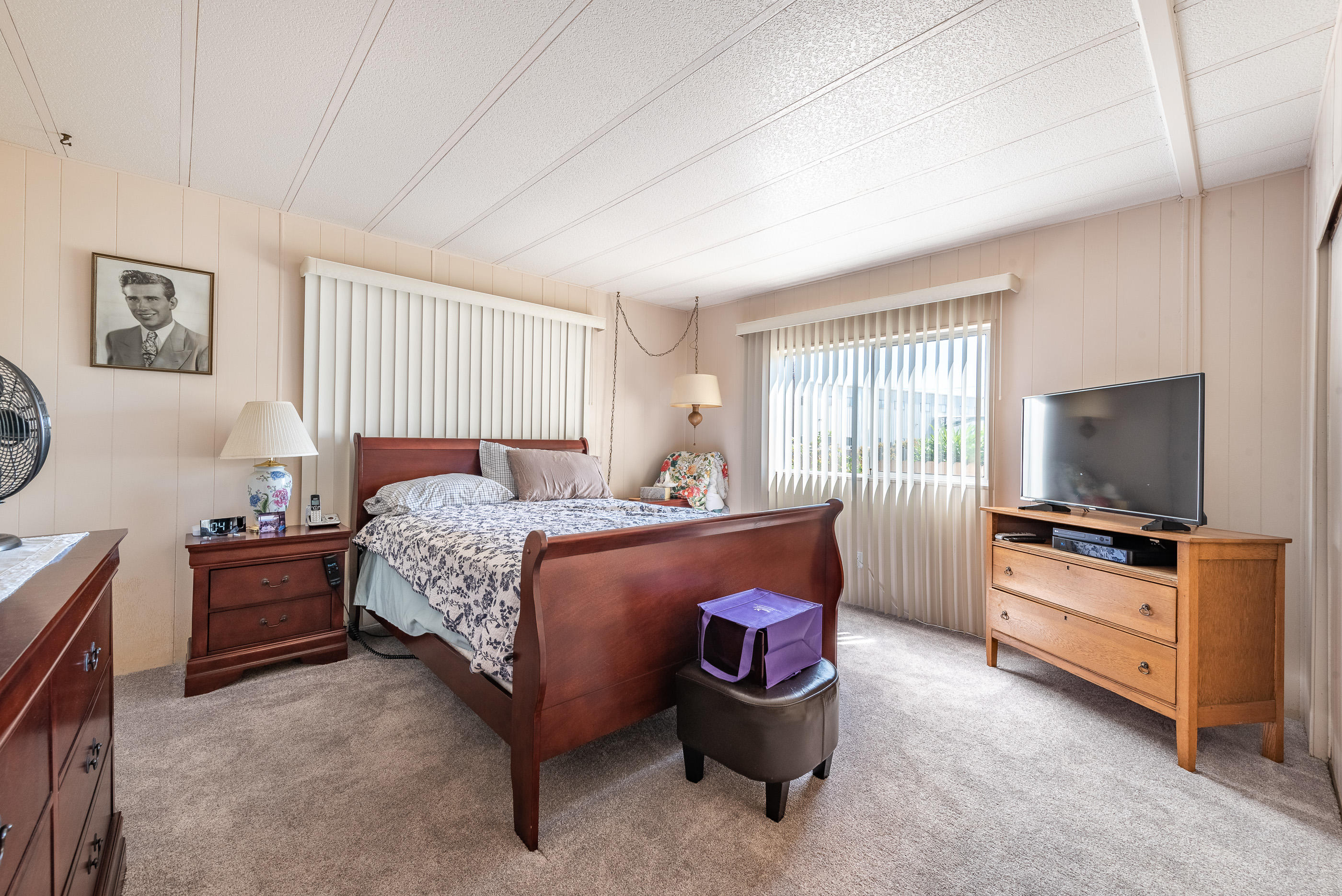 3950 Via Real, Unit 129 Carpinteria, CA 93013 - Photo 15 of 35 a bedroom with a bed and furniture flat screen tv