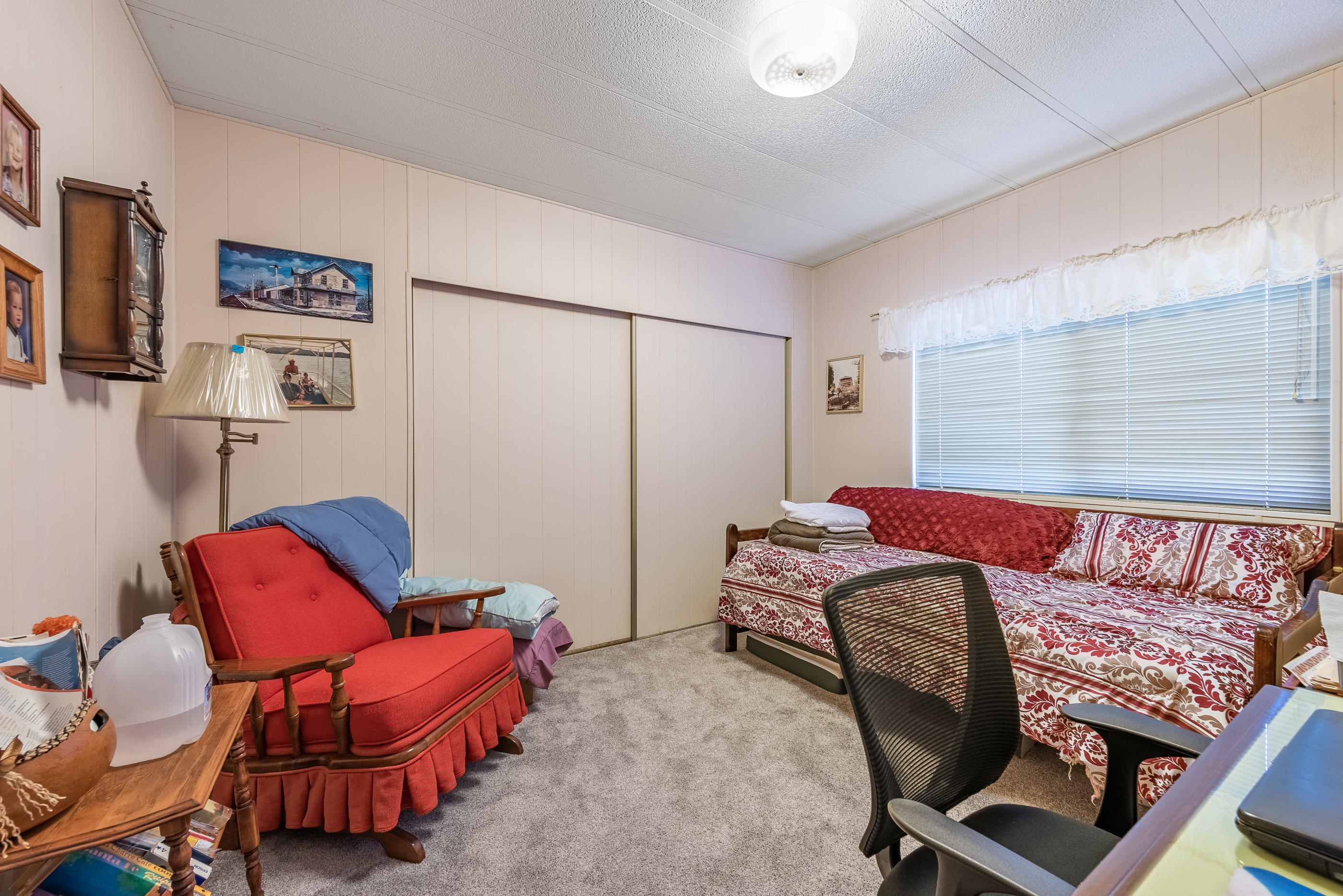 3950 Via Real, Unit 129 Carpinteria, CA 93013 - Photo 21 of 35 a bedroom with a bed and chair