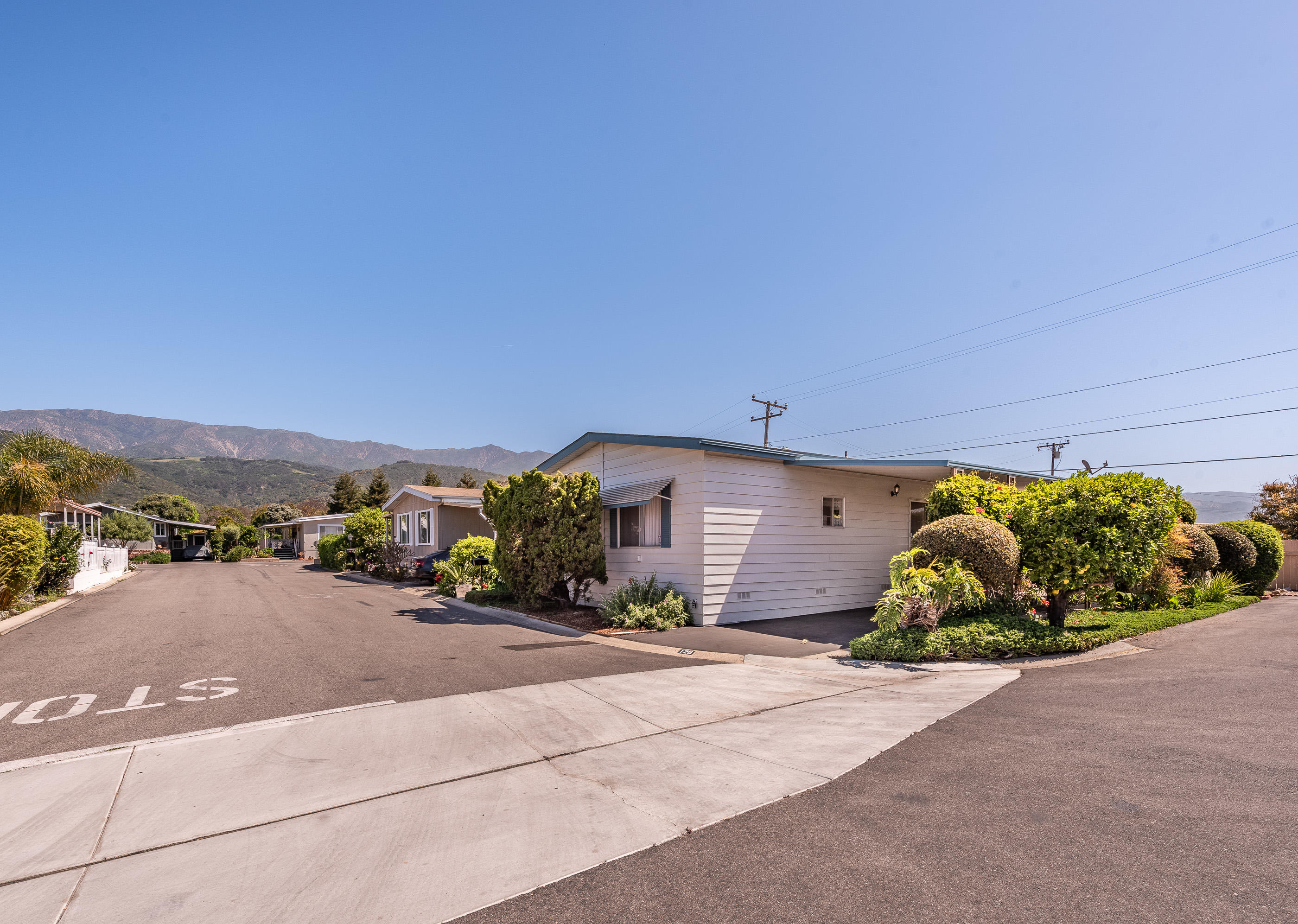 3950 Via Real, Unit 129 Carpinteria, CA 93013 - Photo 3 of 35 a front view of a house with a yard and mountain view