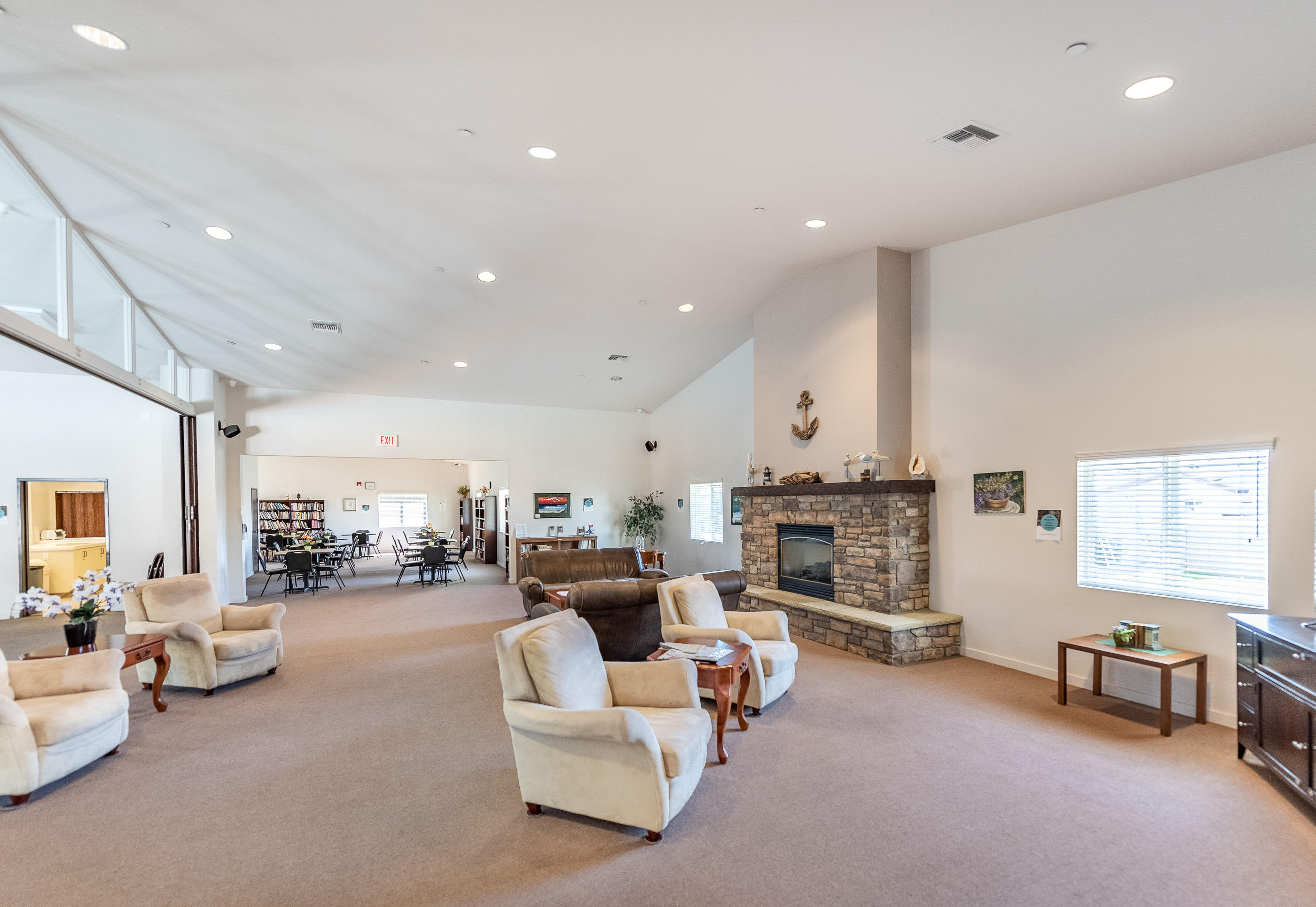 3950 Via Real, Unit 129 Carpinteria, CA 93013 - Photo 31 of 35 a living room with furniture white fireplace and couches with wooden floor