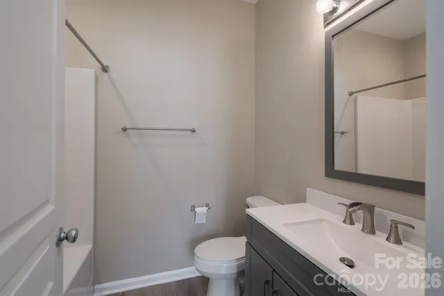 a bathroom with a sink toilet vanity and shower