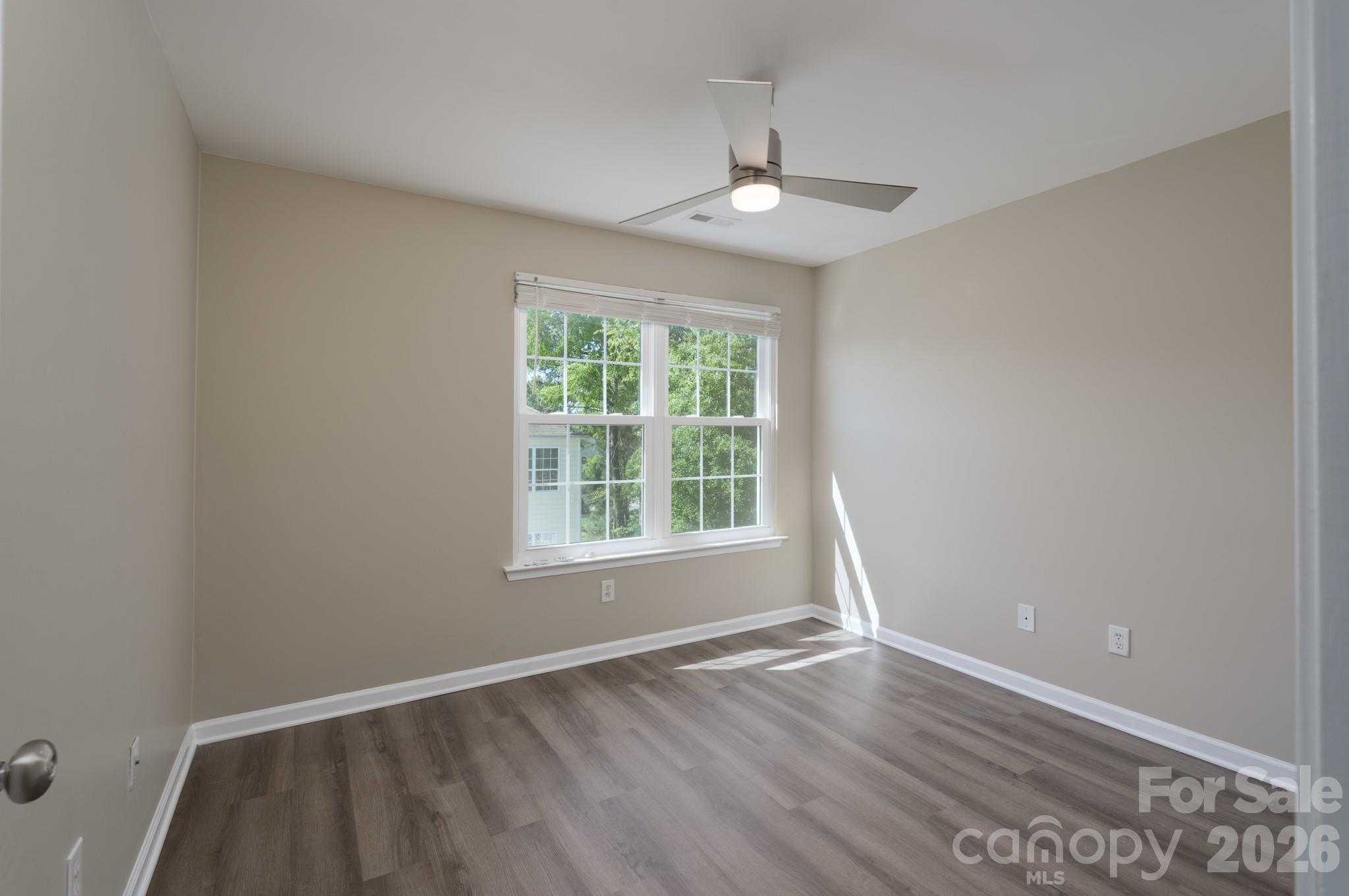 643 Brickdust Court Fort Mill, SC 29708 - Photo 20 of 28 an empty room with wooden floor chandelier and window