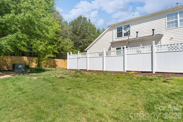 a sign that is sitting in front of flowers