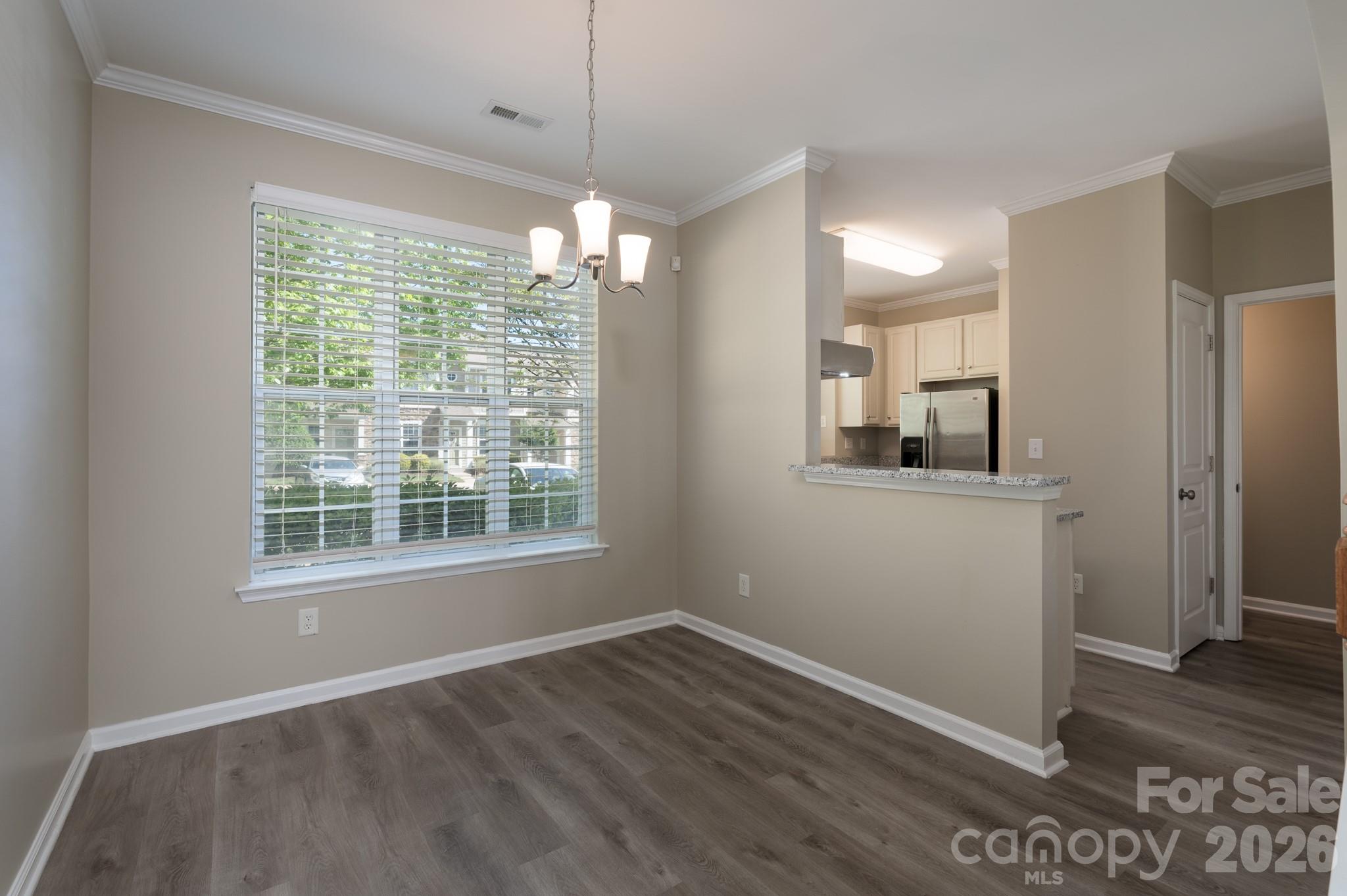 643 Brickdust Court Fort Mill, SC 29708 - Photo 6 of 28 a view of an empty room with wooden floor and a window