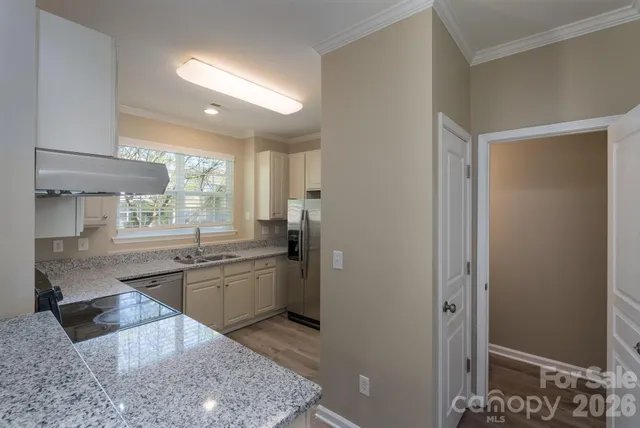 a large bathroom with a granite countertop sink a toilet and bathtub
