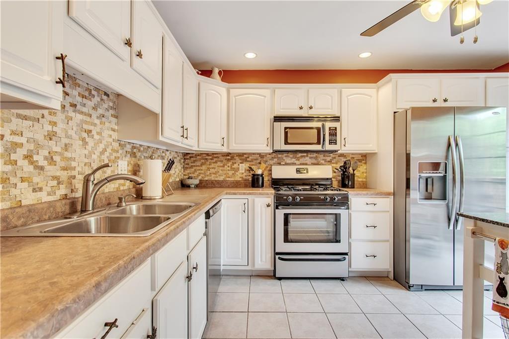 210 Grace Street McKees Rocks, PA 15136 - Photo 5 of 22 The kitchen includes stainless appliances and a tile back splash.