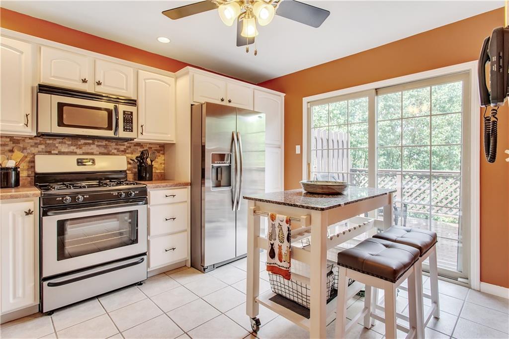 210 Grace Street McKees Rocks, PA 15136 - Photo 6 of 22 The kitchen includes a sliding glass door that leads to the deck.