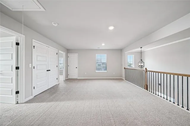 a view of a livingroom with entryway & window