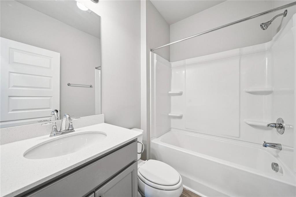 1547 Stinson Lane Locust Grove, GA 30248 - Photo 23 of 43 a bathroom with a sink toilet and shower