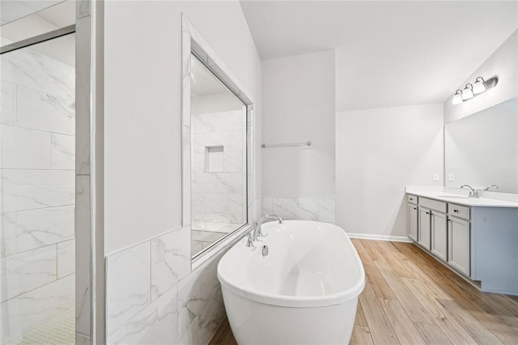 1547 Stinson Lane Locust Grove, GA 30248 - Photo 30 of 43 a bathroom with a bathtub and a sink