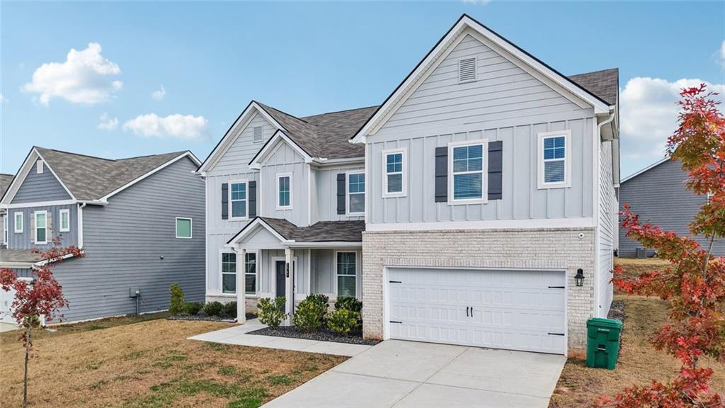 1547 Stinson Lane Locust Grove, GA 30248 - Photo 3 of 43 a front view of a house with a garden