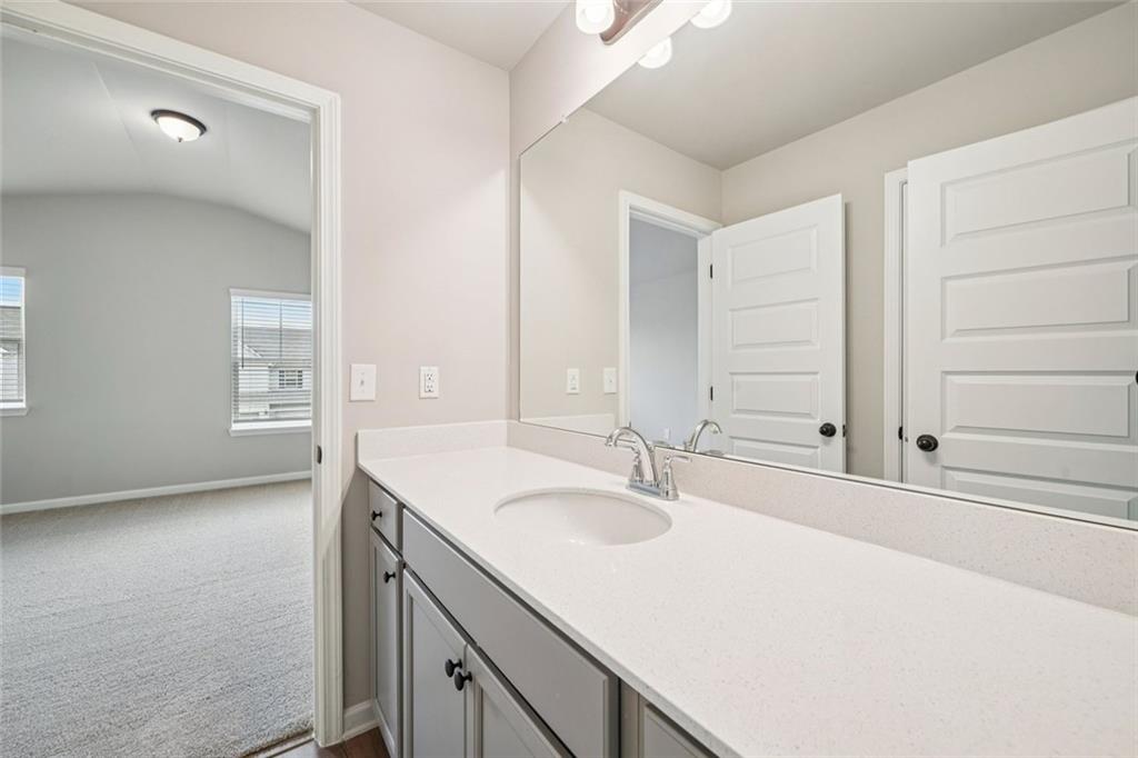 1547 Stinson Lane Locust Grove, GA 30248 - Photo 32 of 43 a bathroom with a sink and a mirror