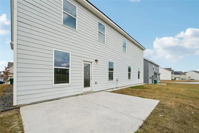 a view of a house with a backyard