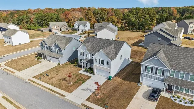 an aerial view of a house with a yard