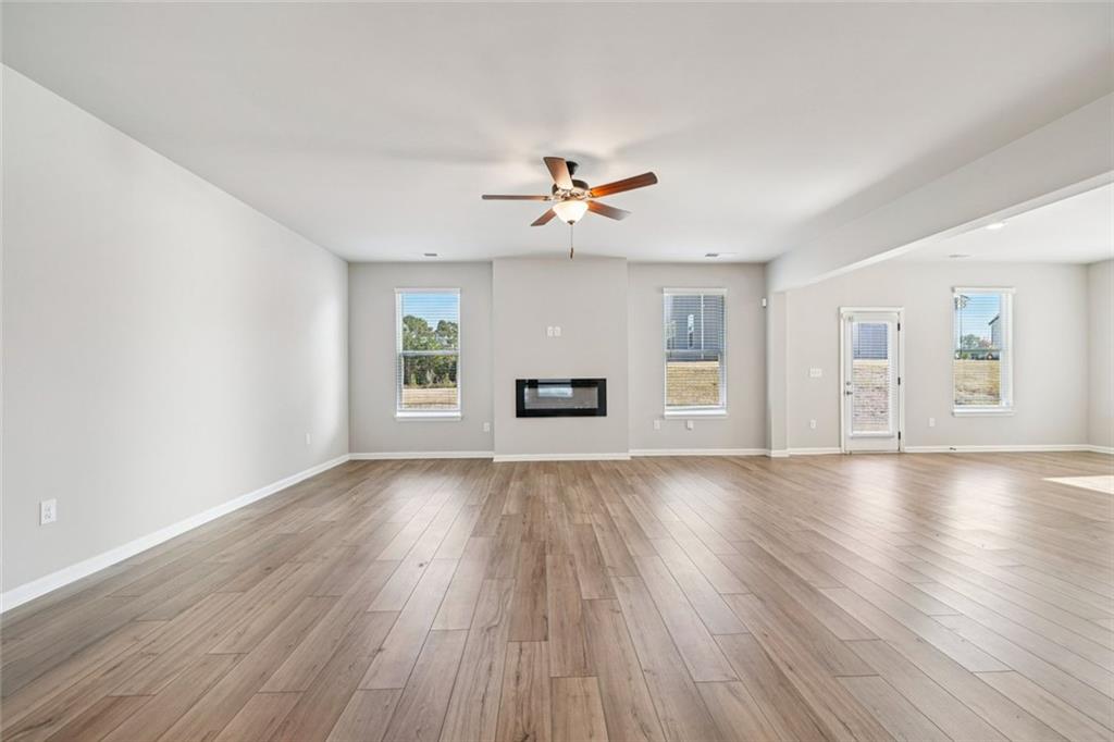 1547 Stinson Lane Locust Grove, GA 30248 - Photo 6 of 43 a view of an empty room with window and wooden floor