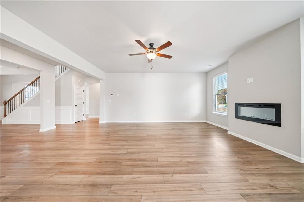 1547 Stinson Lane Locust Grove, GA 30248 - Photo 7 of 43 a view of an empty room with window and wooden floor